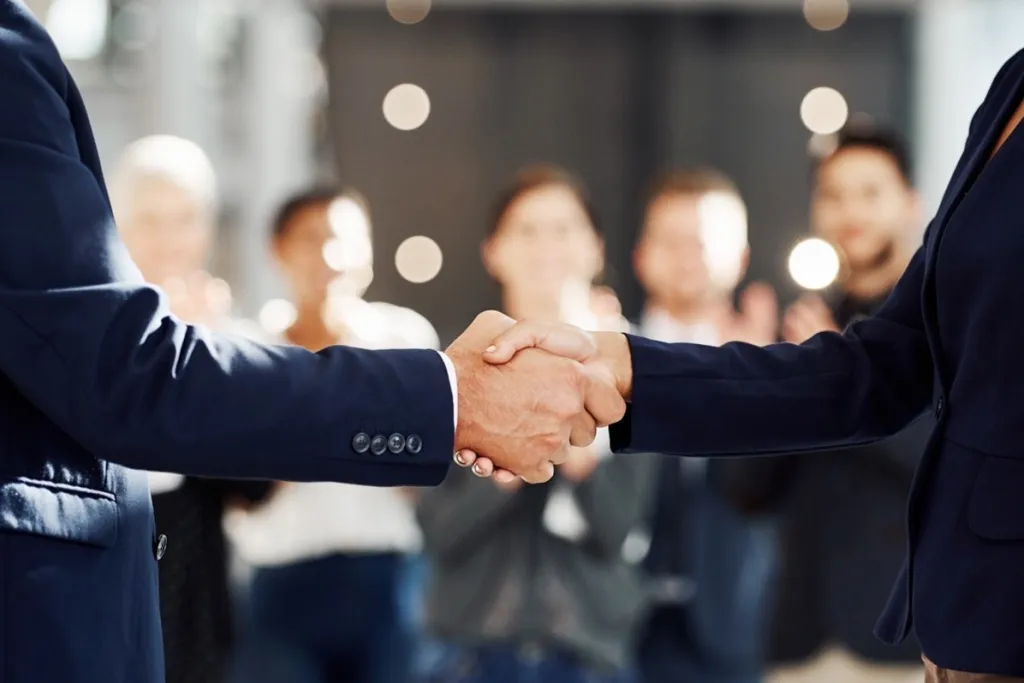 Two individuals shaking hands
