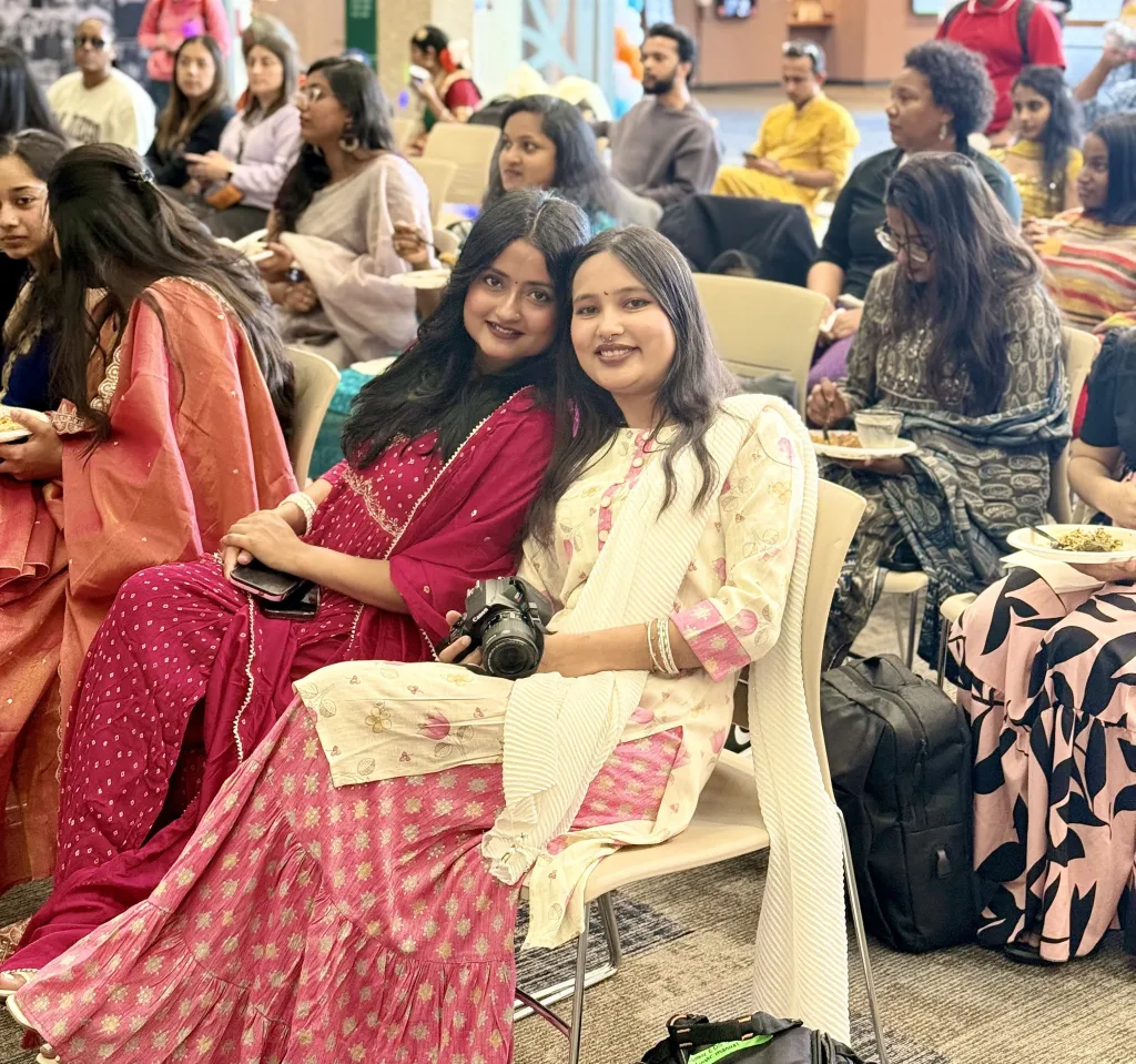 Two smiling women in south Asian attire