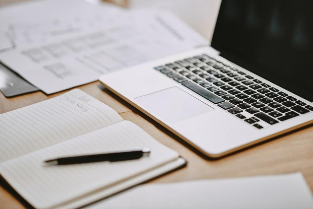 Laptop and notebook on desk