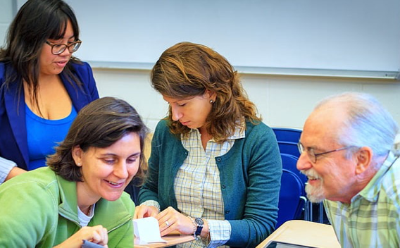 Multiple generations of people alking in a classroom