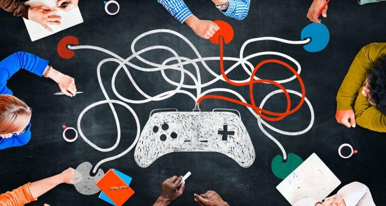 People using chalk to draw a gaming controller and cords