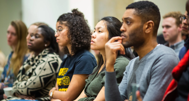 Students sitting in row looking straight ahead