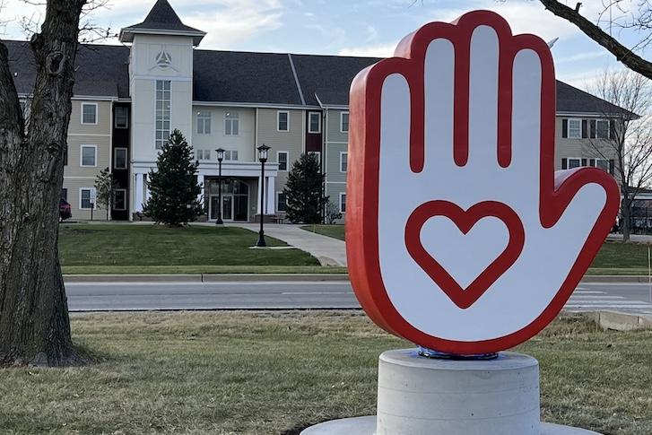 Hand sculpture with a heart symbol on the palm