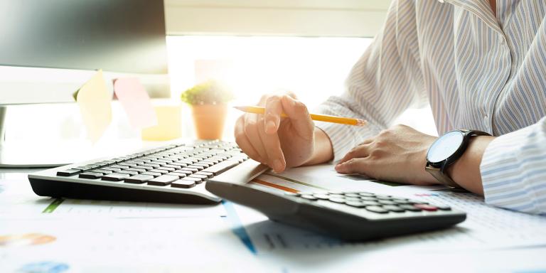 Bookkeeper with computer and calculator