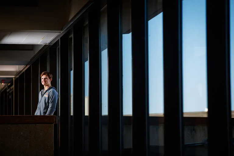 Caucasian male student standing indoors