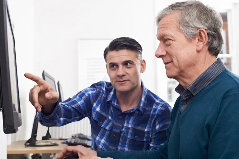 Two men in front of a computer