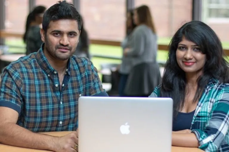 Two students in front of computer