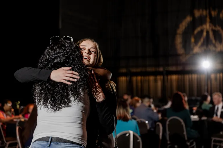 students hugging