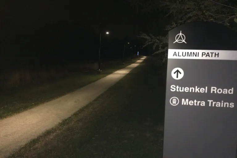 A picture of the Alumni Path looking west, during the night.
