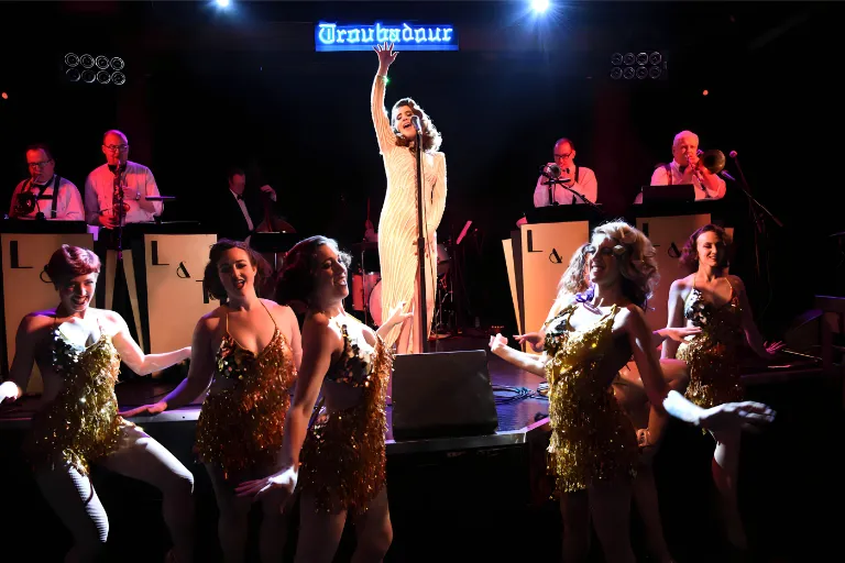 Singer and big band perform onstage