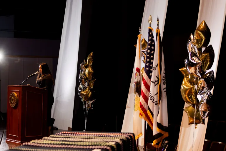 speaker at podium with cords in foreground