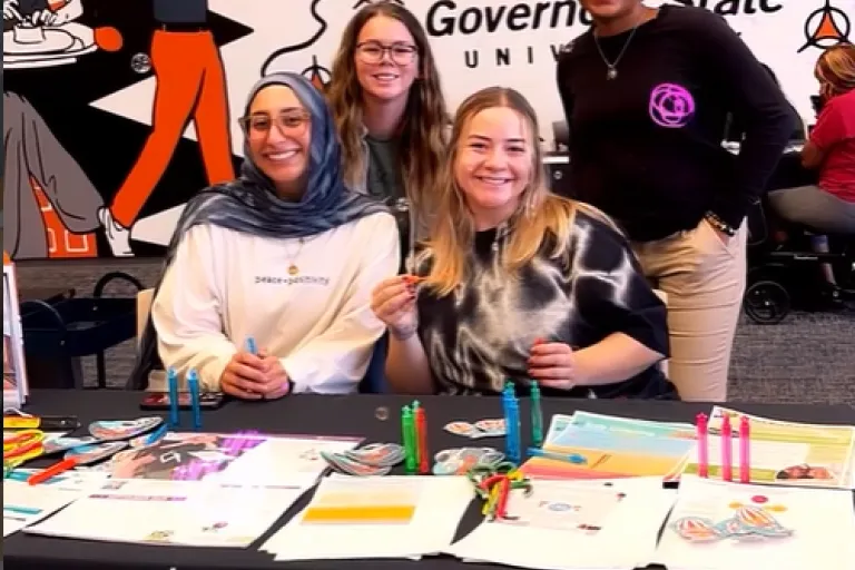 NSSLHA Students sit at a booth for a student event