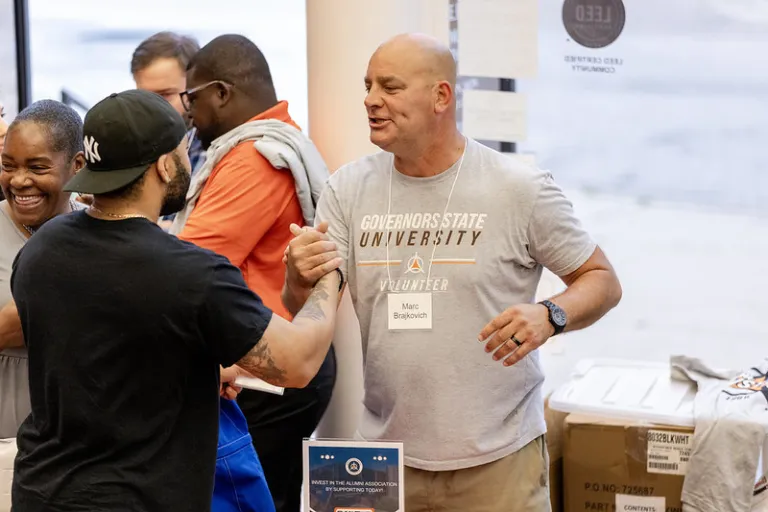 Alumni greeting each other at event
