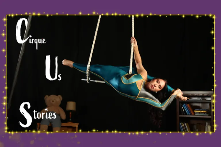 Cirque Us Stories aerial performer on trapeze indoors with minimalist stage setup and stylized title text