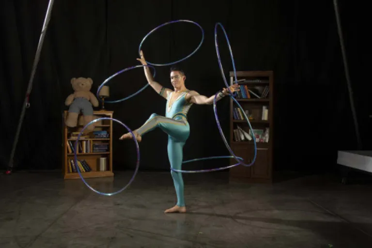 A low-resolution image for 'Cirqueus Stories', depicting a vibrant, theatrical scene or performers.