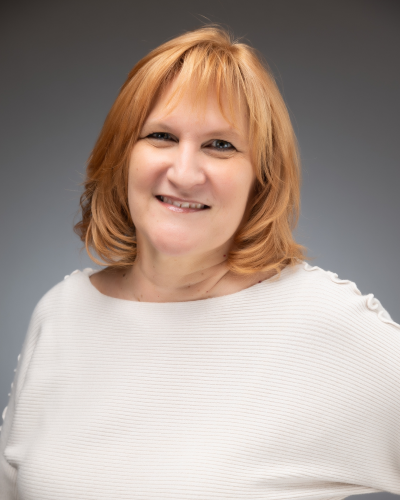 Woman with red hair and white shirt