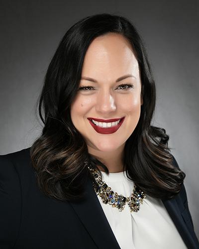 Woman with long black hair, in which shirt and black jacket