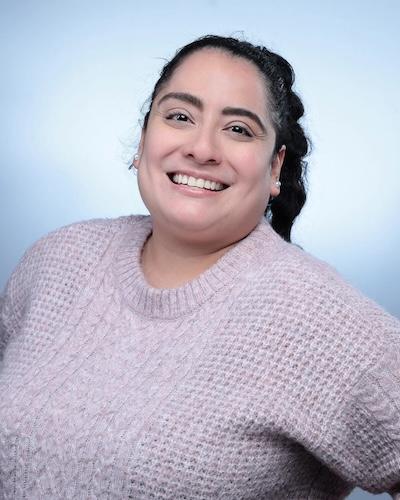 Smiling woman in pink sweater, professional headshot