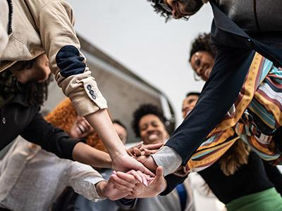Group of people stacking hands in a huddle