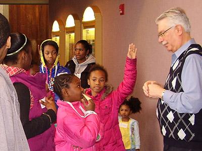 A person talking to a group of children