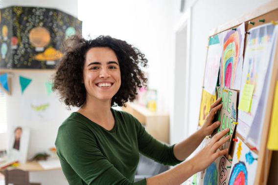 A young teacher setting up her blackboard