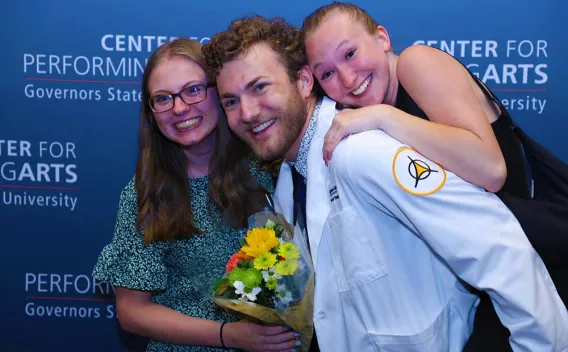 A group of people holding flowers