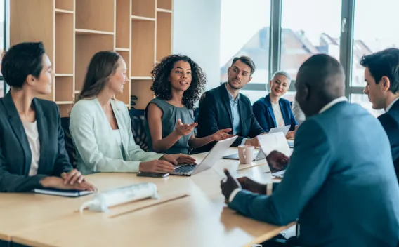 A group of people talking at a table
