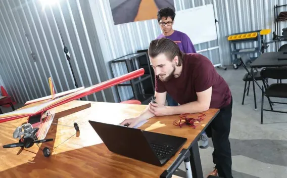 Student looking at a drone plane