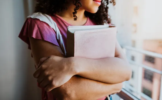 image of student holding her books
