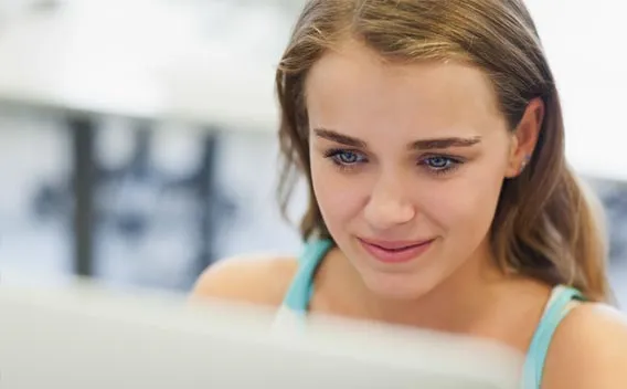 A young female student at a computer monitor