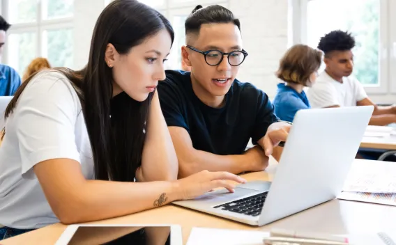 Students looking at laptop