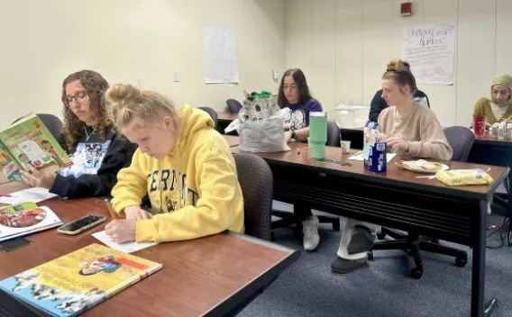 Diverse group of students, sitting in classroom, working on various projects