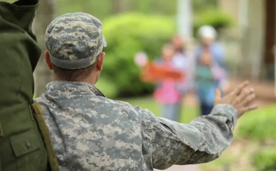 Image of the back of an individual dressed in military uniform