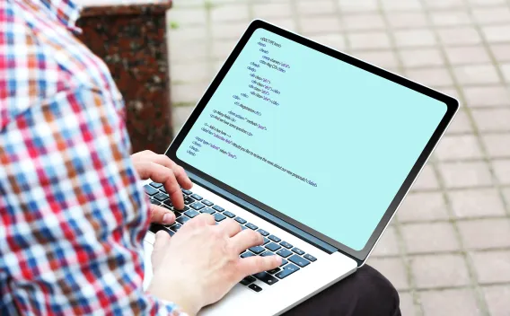 Man html coding on laptop