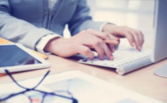 hands typing on computer