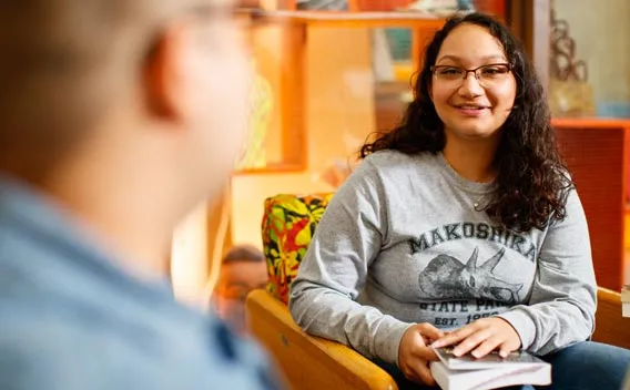 Female college student having a conversation with a male student