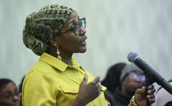 Woman speaking at a microphone