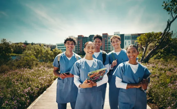 A group of healthcare students smiling and standing outside
