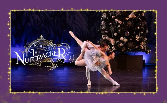 The Nutcracker ballet performance featuring two dancers in lift pose beside decorated Christmas tree and event title text