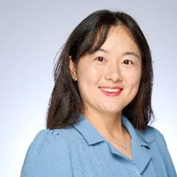Asian woman with blue shirt smiling 