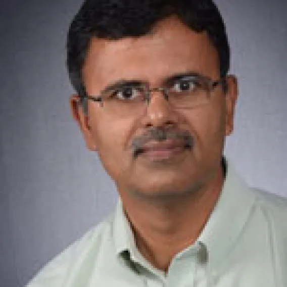 Asian Man with glasses wearing green shirt 
