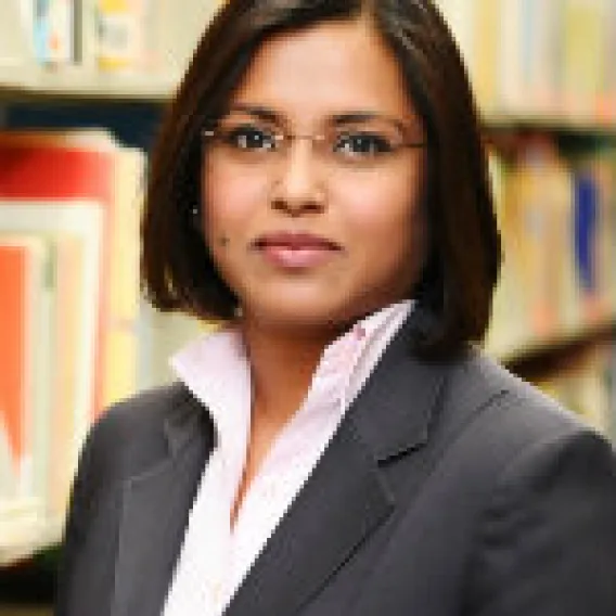 Asian woman with glasses and black jacket 